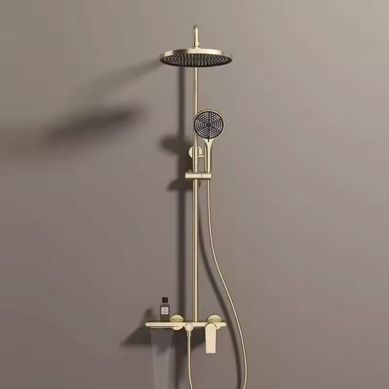 Colonne de douche dorée avec tablette